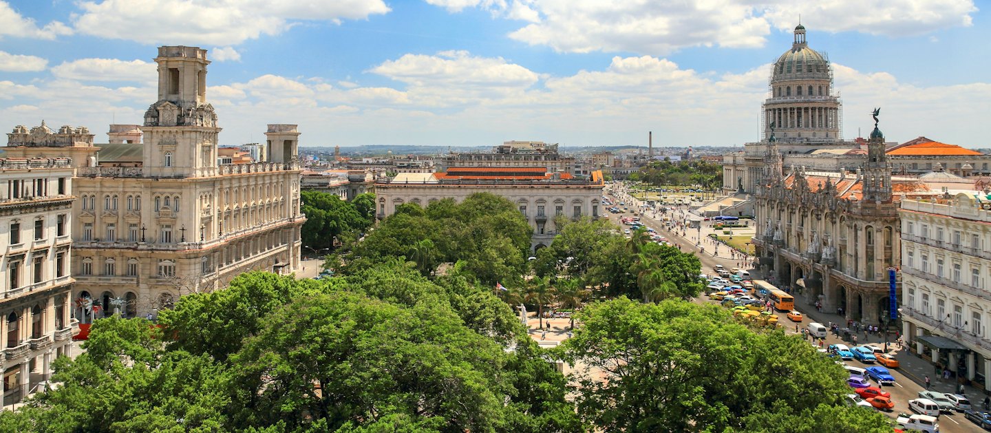 Aerial view of a historic city plaza with buildings and trees.