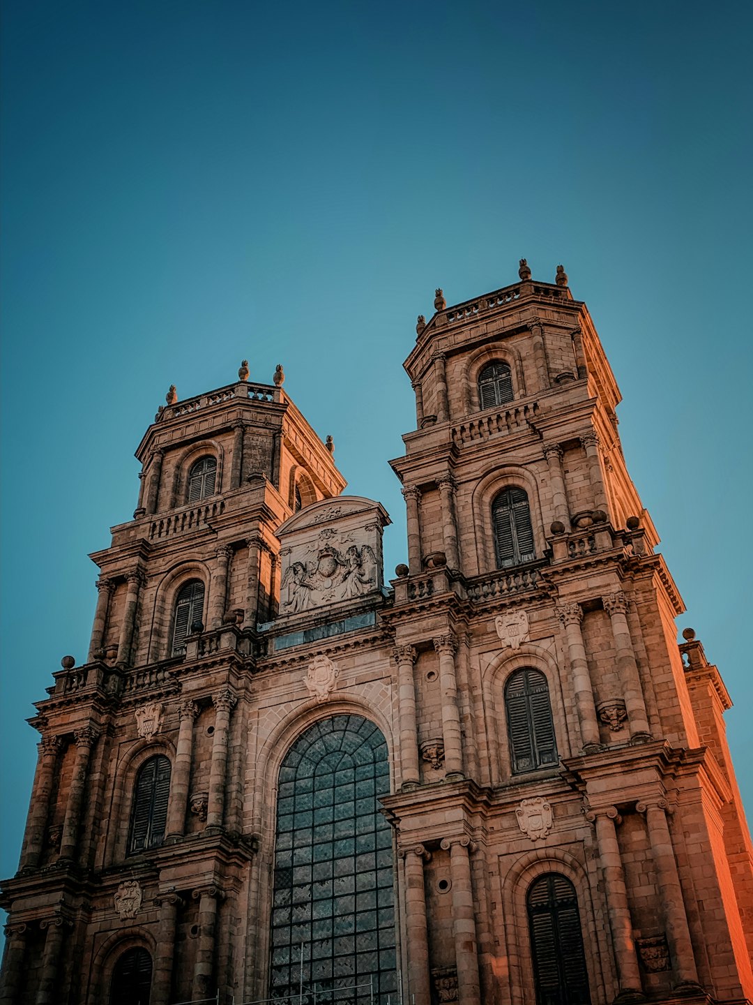 Stone baroque cathedral with two towers and ornate facade.